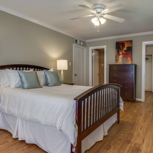 a bedroom with a bed and a fan
