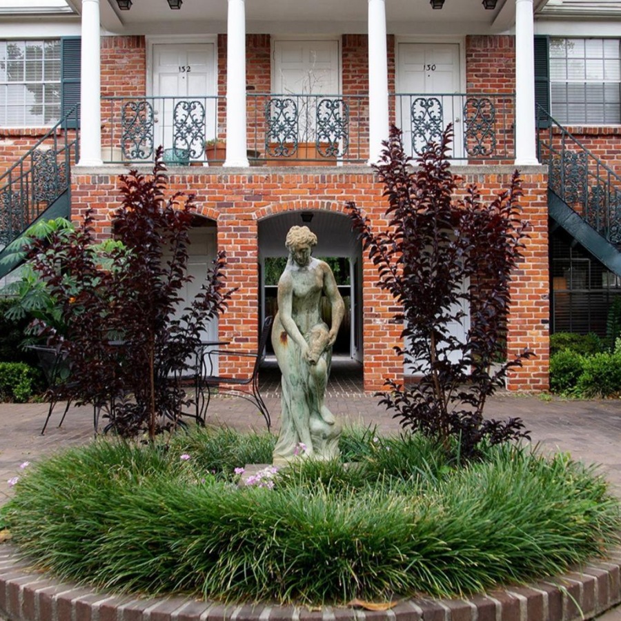 a statue in front of a building